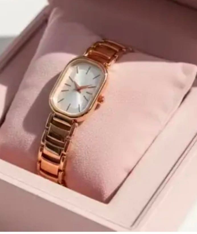 Gold rectangular watch in a pink gift box